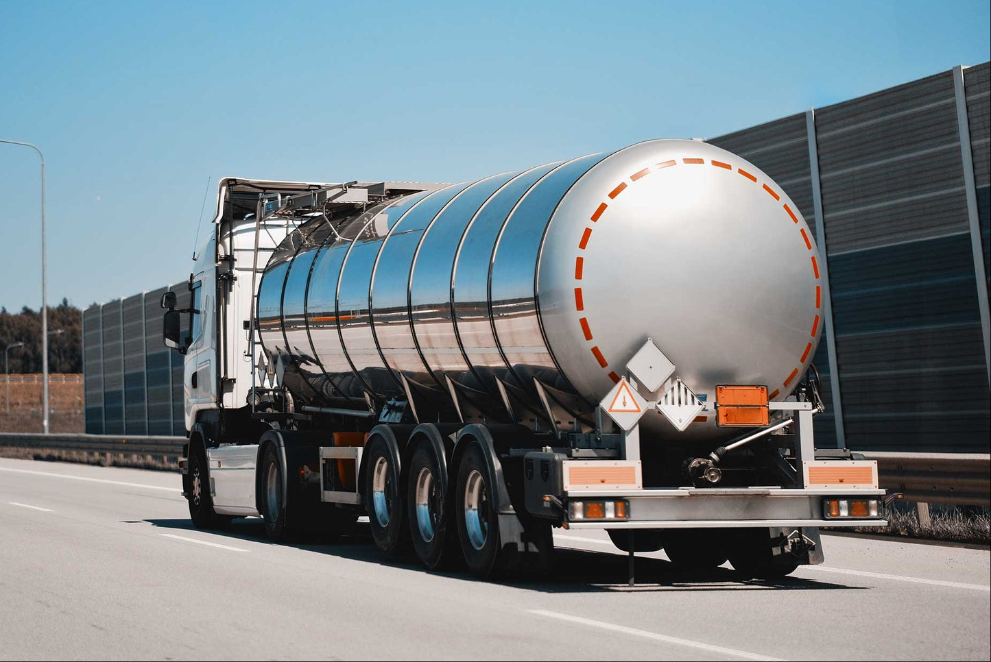 Tanker truck on a highway with clear blue sky